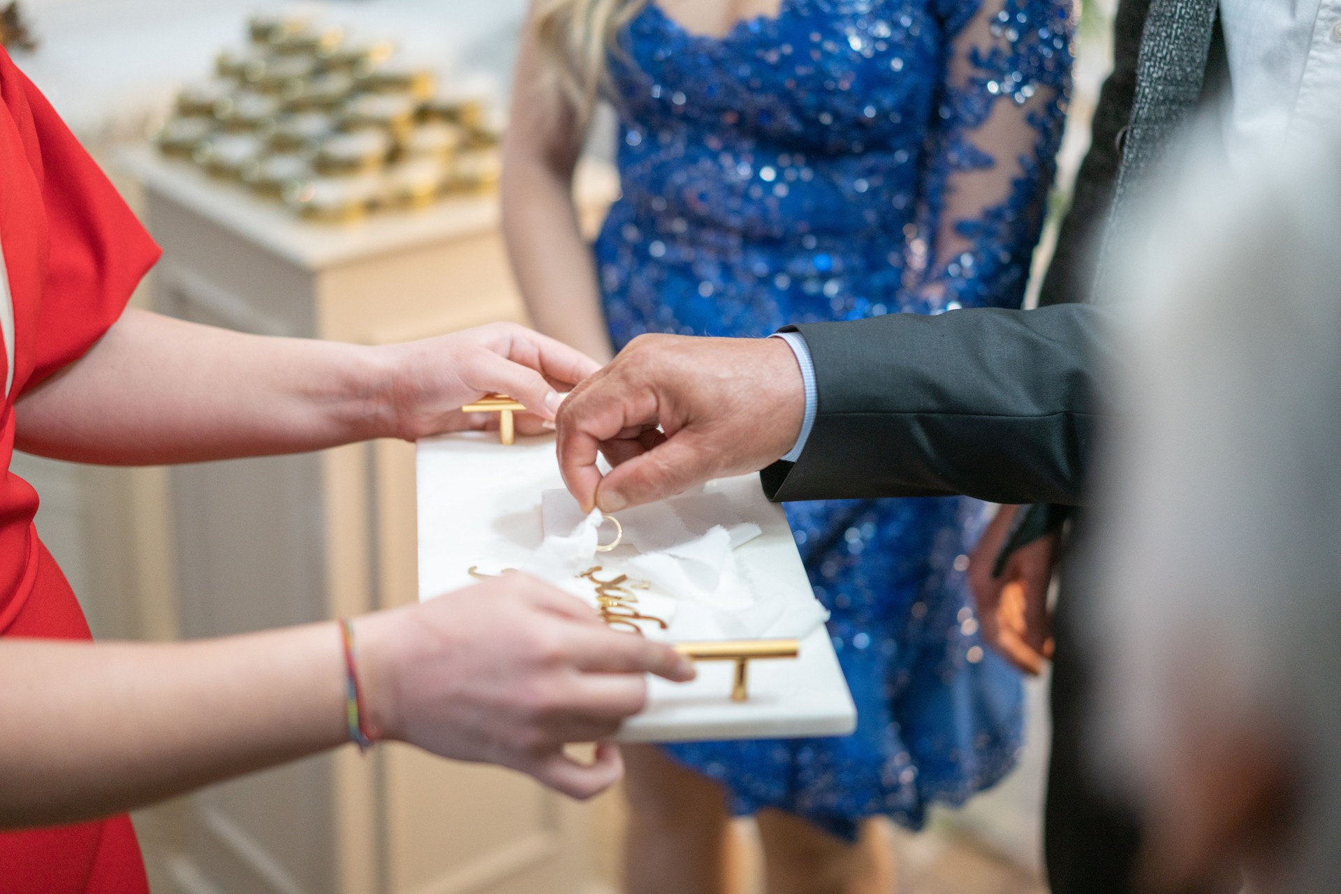 Engagement rings on tray tied with ribbon, preparing for wedding ceremony